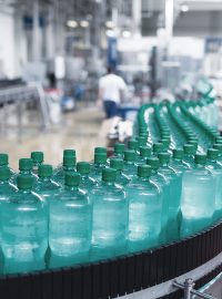 Bottles on conveyor belt in a food and beverage packing plant.