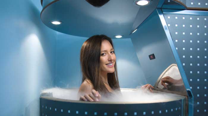 Woman in cryotherapy tank, commonly used in cryo health centers.